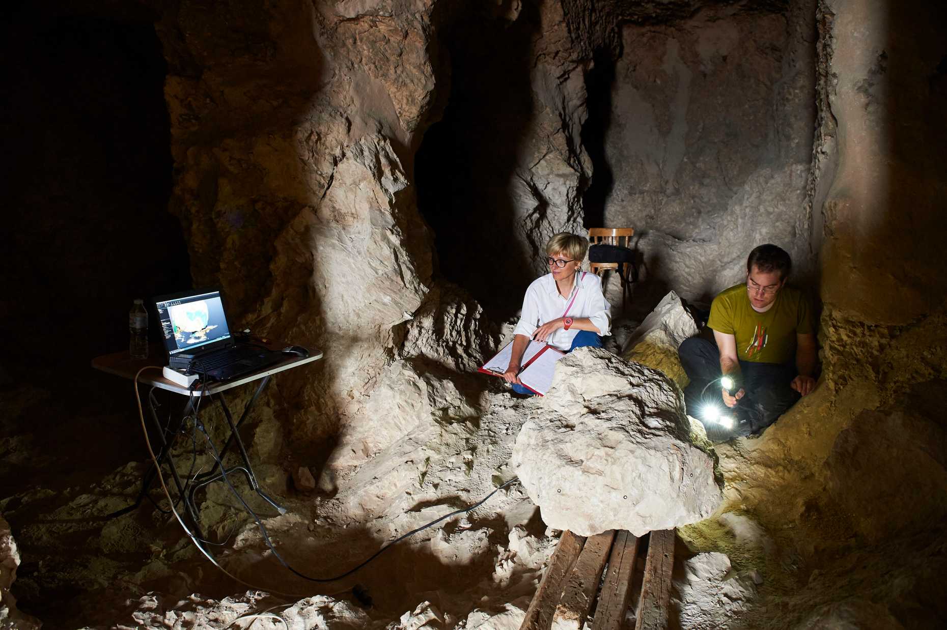 Image of two persions performing measurements in a cave